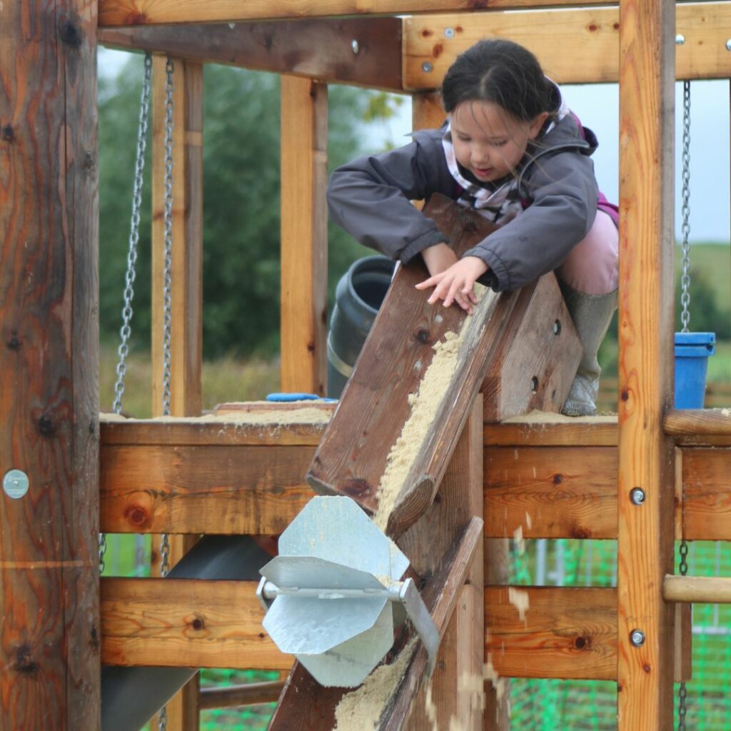 Wild Cinema Week - outdoor adventures and nature-inspired fun - girl playing in a sand pit